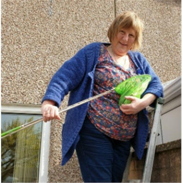 Cats Protection volunteer saving a kitten with fishing net