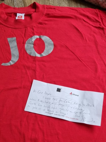 red t-shirt with 'Jo in silver and a handwritten note from Jo Brand