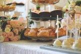 Cake stand filled with cakes, sandwiches and pastries