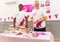 Two men wearing Cats Protection t-shirts standing behind a cake stall