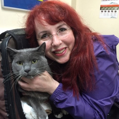 grey cat with woman with red hair