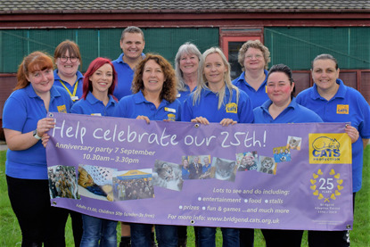 Cats Protection volunteers and staff holding a banner