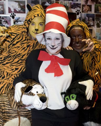 three people dressed as cats and tigers with face paint