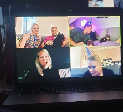 laptop showing Zoom call with five people and two cats in four frames