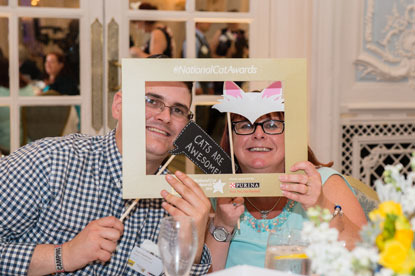 Man and woman posing with cat masks at the National Cat Awards 2016