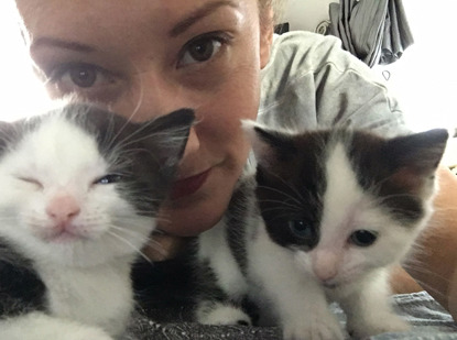 Frankie Seaman with two black and white kittens