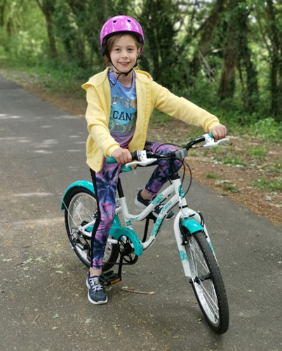 young girl on turquoise bicycle