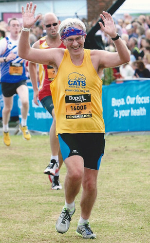 man running in Cats Protection vest