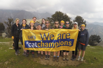 group of Cats Protection fundraisers at top of a hill holding banner