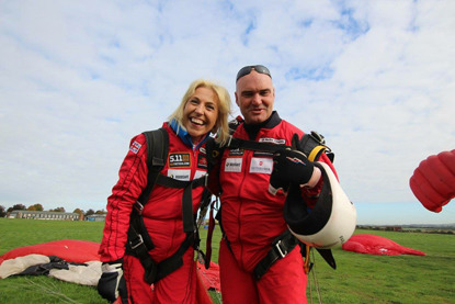 woman and man on ground after doing tandem skydive