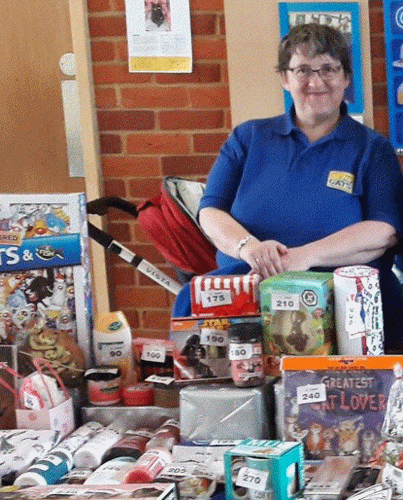 woman in Cats Protection t-shirt at a raffle table