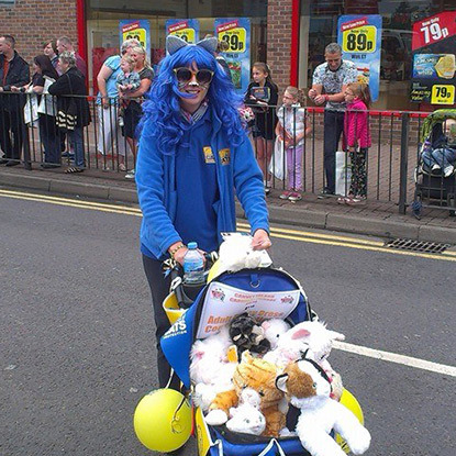 lady with blue wig in Cats Protection jumper at a carnival