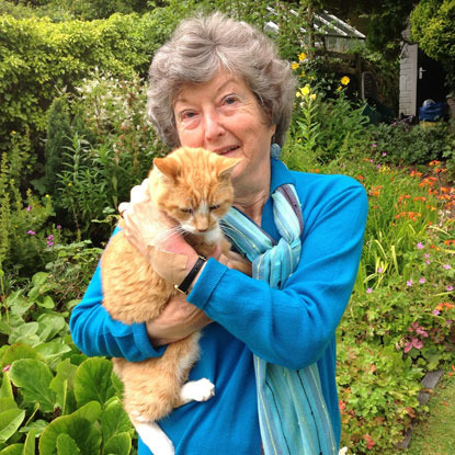 elderly woman holding ginger cat