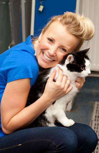 Carley Stenson hugging black and white cat