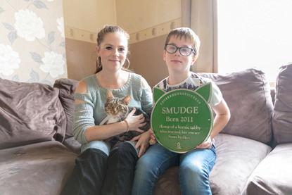 Woman and young boy holding pet cat plaque