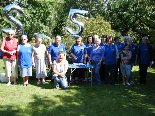 Cats Protection volunteers with 25 number balloons