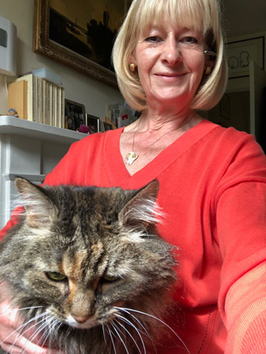 blonde woman with tabby cat on her lap