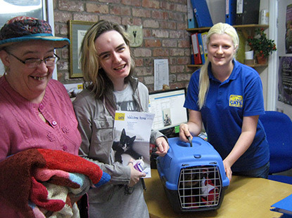 three women with a cat carrier