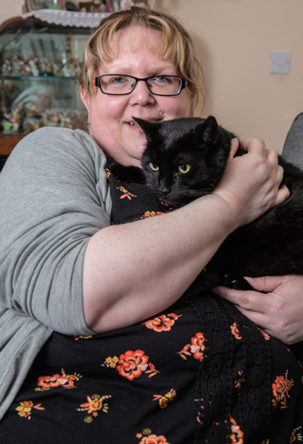 blonde lady holding black cat