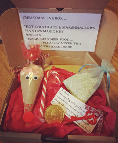 Christmas Eve box containing hot chocolate mix with marshmallows, Santa's magic key, sweets and magic reindeer food