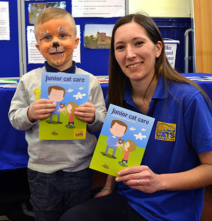 Cats Protection volunteer with little boy with face painted as a tiger