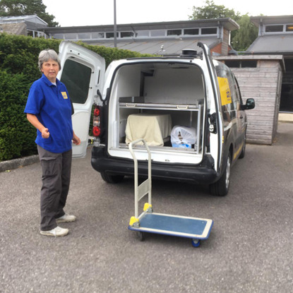 female Cats Protection volunteer standing next to Cats Protection van