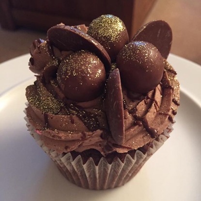chocolate cupcake with chocolate icing and chocolates on top