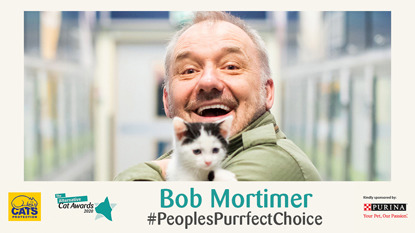 Bob Mortimer holding black and white kitten