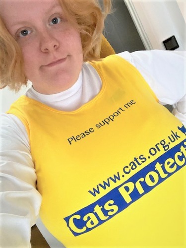 blonde woman wearing yellow Cats Protection vest