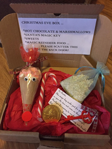 Christmas Eve box with a cone of hot chocolate and marshmallows, magic reindeer food, a key for Santa and sweets