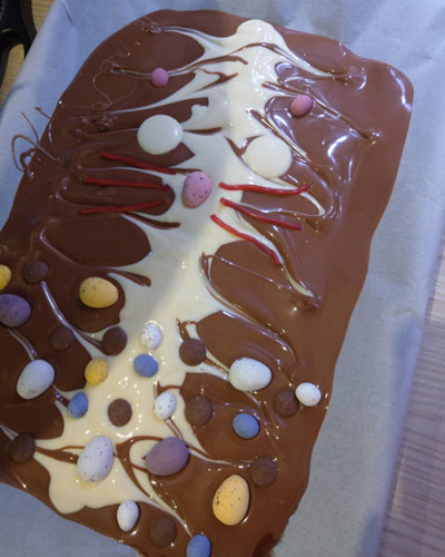 melted white and milk chocolate slab topped with mini eggs