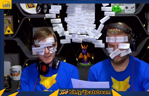 Two men wearing blue Pawsome Players t-shirts with post-it notes stuck on their faces