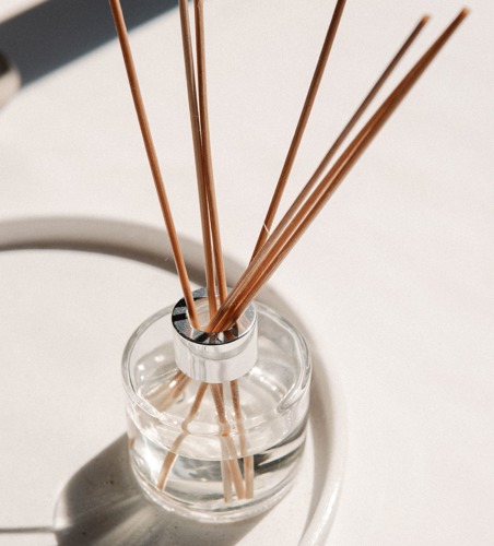 reed diffuser containing a clear essential oil