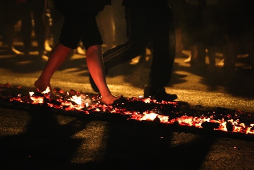 bare feet walking across burning hot coals