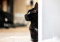 Side view of a black cat behind a wall