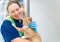A veterinary nurse holding a ginger tabby.